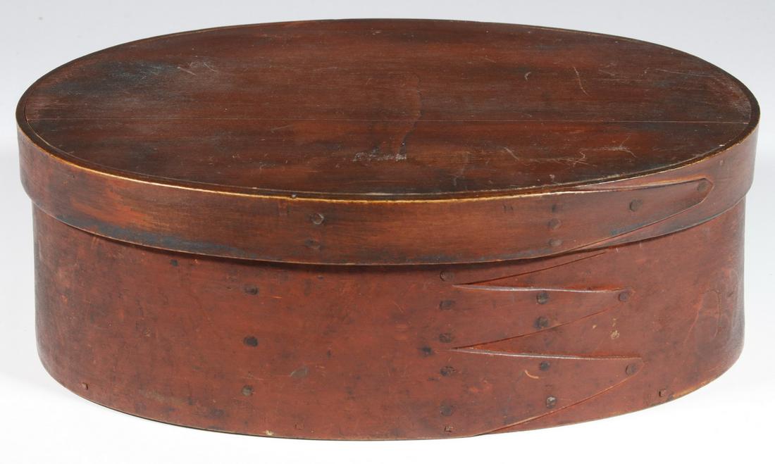 19TH C. SHAKER OVAL PANTRY BOX: Large Oval Box in Red Casein Paint, tack finger joined bent ash with pine bottom plate, friction fit lid, 4" x 9" x 12". Good condition. Provenance: From the estate of Richard Suydam, Ellsworth, ME.