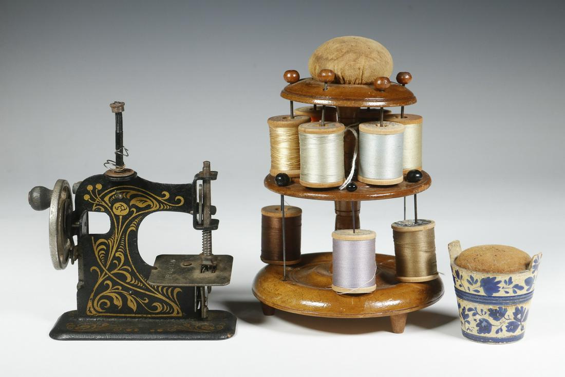 (3 PCS) ANTIQUE SEWING COLLECTIBLES: Group of (3) Sewing Items, incl: German made miniature hand crank child's working sewing machine, with retractable foot, marked 'No. 128150' on plate, decorative gold floral decal on black body, 5 1/4
