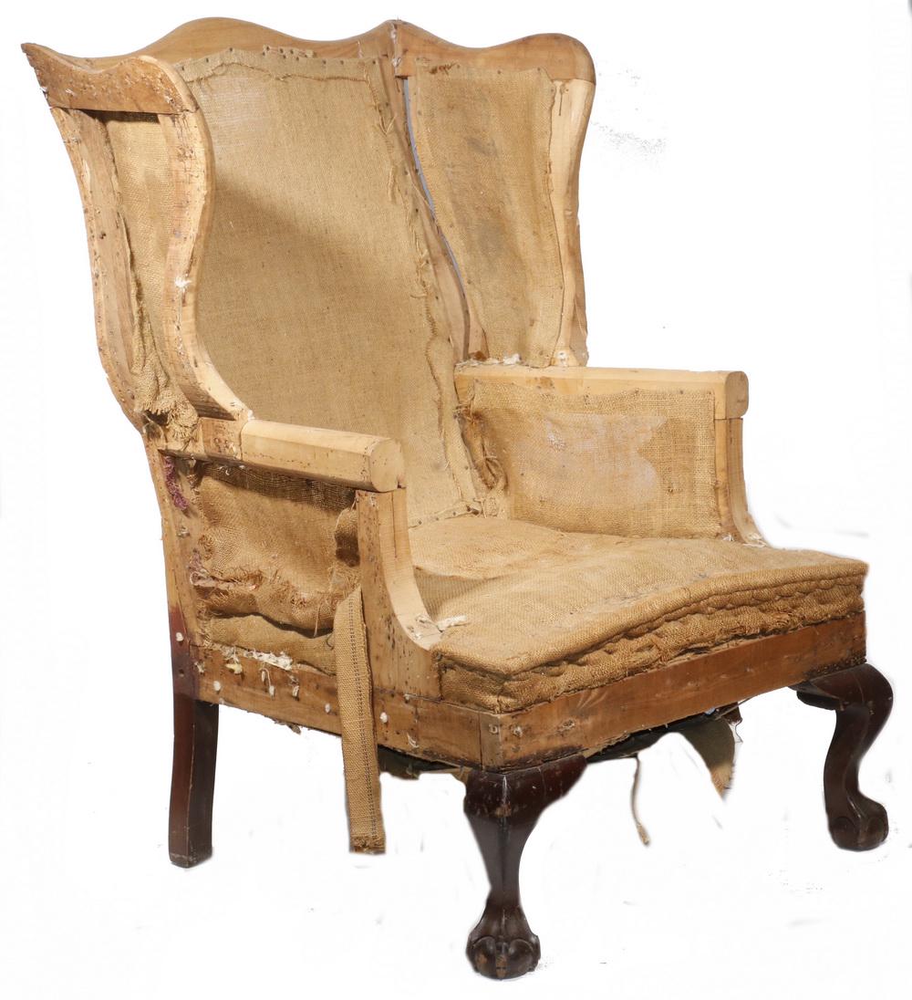 CENTENNIAL CHIPPENDALE WING CHAIR FRAME: Finest Quality Well-formed Stripped American Wing Chair Frame (no upholstery), with shallow camel back, deep sinuous wings, rolled setback arms, retaining burlap covered springs, resting on boldly car