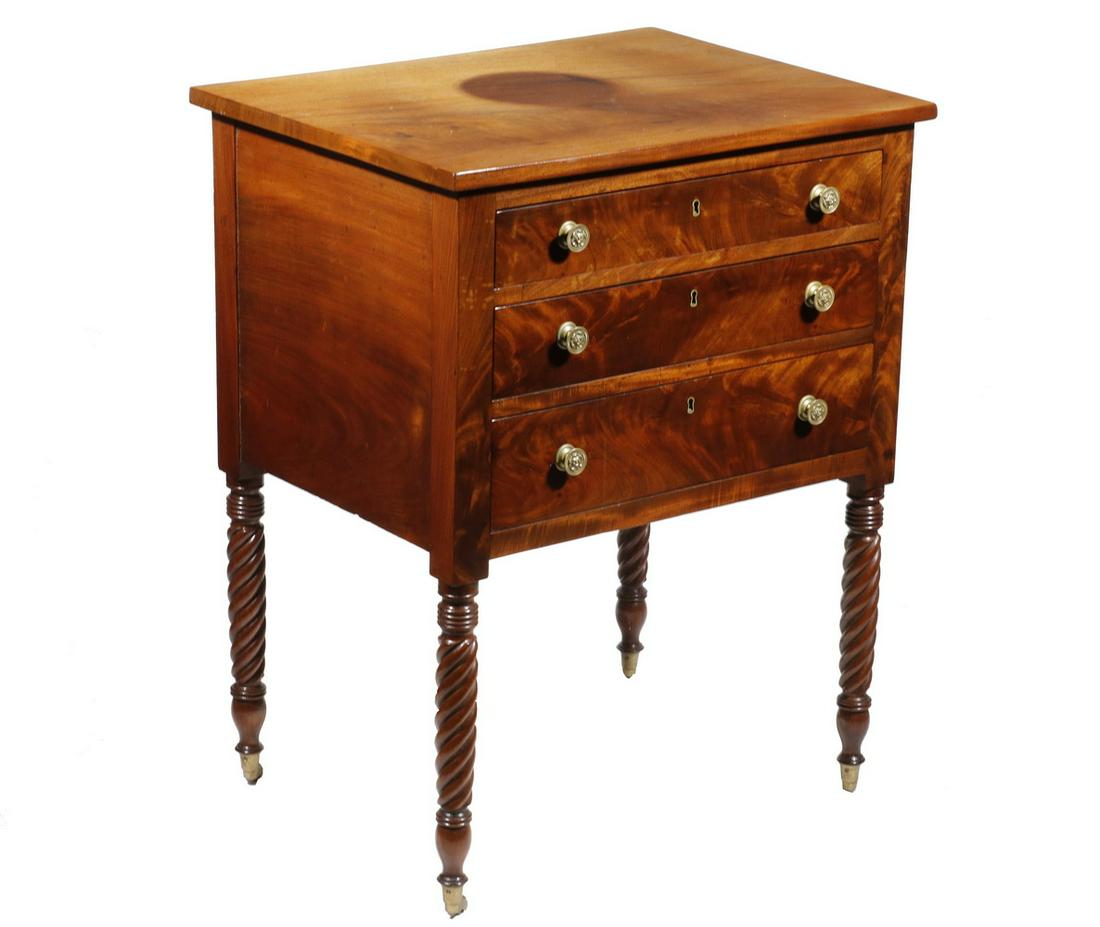 SHERATON PERIOD MAHOGANY STAND: 18th c. Mahogany Three-Drawer Stand, with overhanging top, figured mahogany front, three drawers with round brass pulls and brass escutcheons, set on turned barley twist legs with brass casters, 31" h