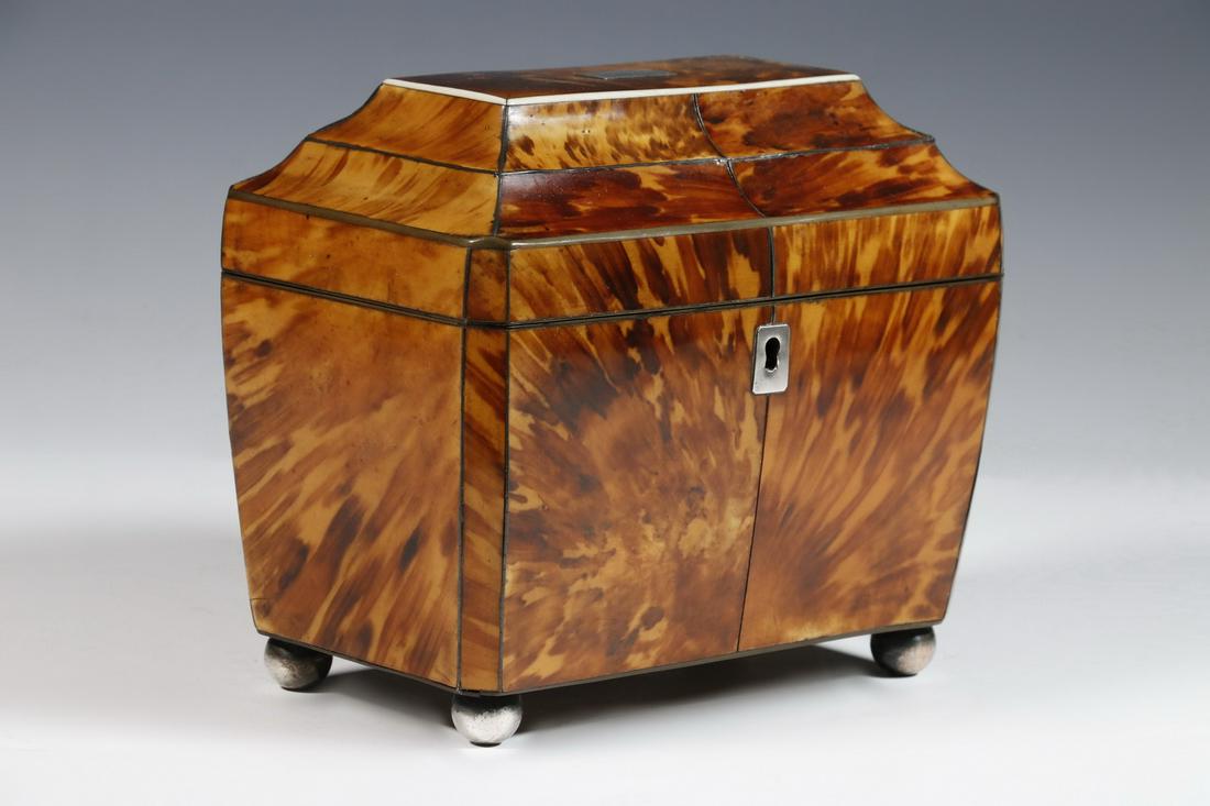 TORTOISESHELL TEA CADDY: English 19th c. Sarcophagus Form Tortoiseshell Tea Caddy, with stepped stop, convex shape and canted corners, metal and bone stringing, silver lid plaque and lock escutcheon, set on metal ball form fe