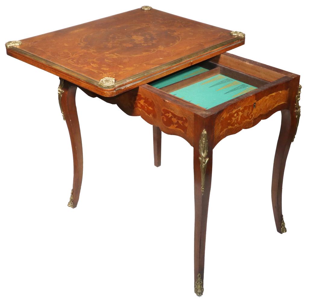 FRENCH MARQUETRY INLAID GAMES TABLE: Marquetry Inlaid Mahogany Bronze Mounted Walnut Gaming Table, top and frieze inlaid with floral and swirl motifs, hinged top opens to a felted surface, with shaped frieze, side drawer with felt lined