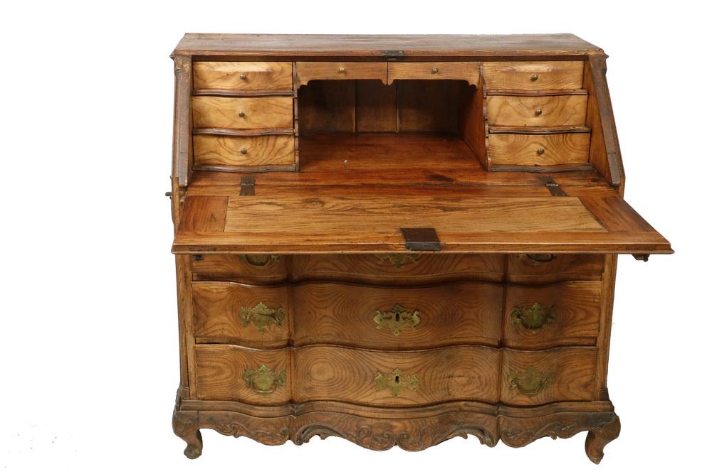 18TH C. SLANT FRONT DESK: French Country Desk with two-panel lid, stepped drawer fitted interior, original iron lock and brass lock escutcheon, stepped serpentine front cabinet with three conforming drawers having the original