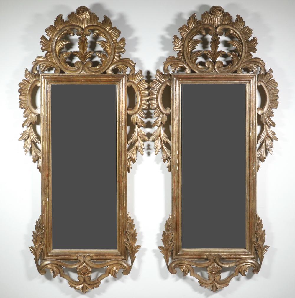 ITALIAN BAROQUE LOOKING GLASSES: Carved and Gilt Narrow Frames with well reticulated leaves and blossoms. 39" x 18" each. Very good condition.