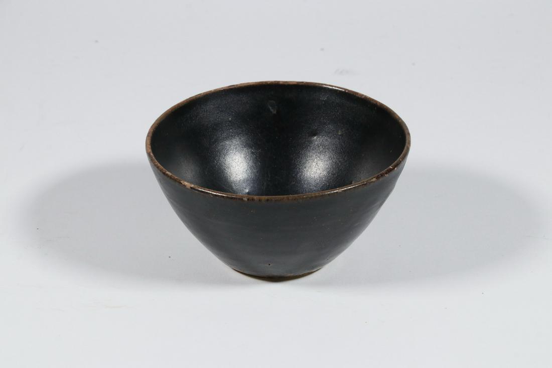 CHINESE JI-ZHOU TEA BOWL: Song Dynasty Jizhou or Chi-Chou Pottery Tea Bowl, 960-1276, with rich blackish-brown glaze, tapered conical shape with shallow unglazed foot, 2 1/4" high, 4 1/2" diam. Unglazed areas. Provenance: Esta