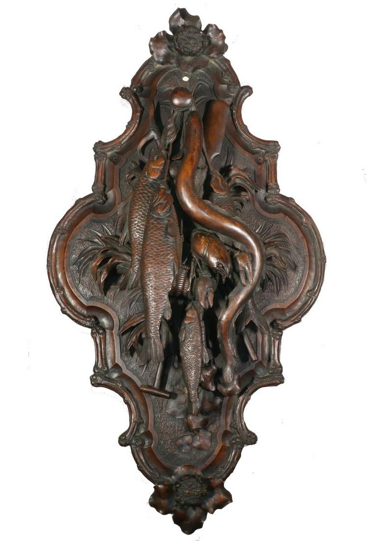 RARE CARVED WALNUT FISHERMAN'S WALL PLAQUE: Rare carved walnut wall plaque of hanging fish, eel and crayfish. Depicts fishing creel, boat paddle and gaff hook. All in high three dimensional relief. Top and bottom have carved water lily flowers,