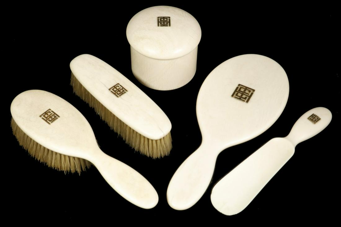 (5 PC) LADY'S DRESSER SET: Circa 1900 Dresser Set consisting of a Hairbrush, Clothing Brush, Hand Mirror, Shoehorn and Powder Jar containing the original ostrich feather puff, each bearing a square entwined 'THE' monogram in 18