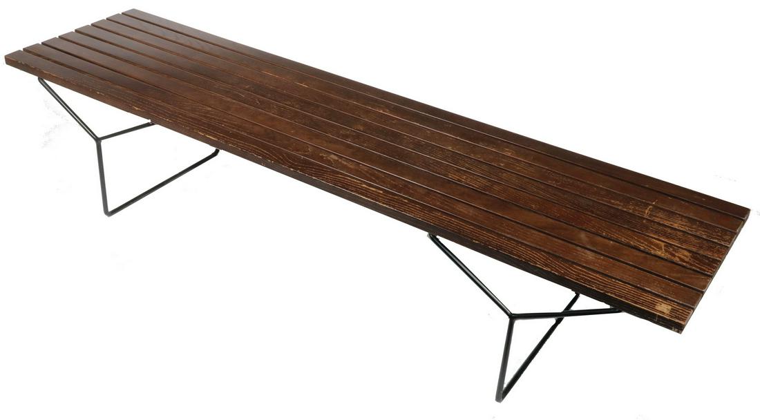 HARRY BERTOIA BENCH BY KNOLL, CIRCA 1962: Mid-Century Modern Bench of dark-stained oak slats raised on Y-shaped trestles made of black painted steel rod, with a Knoll International label, 15" x 72" x 18". Wear to finish.