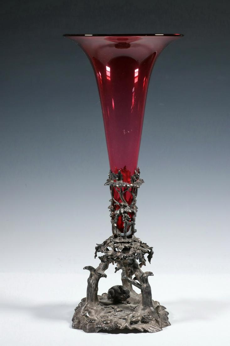 JAMES DIXON & SONS SILVER-PLATE & GLASS TRUMPET VASE: Late 19th c. English Cranberry Glass Trumpet Vase with Figural Silver-Plate Mount by James Dixon & Sons, Sheffield, #3201, mount depicts a rabbit beneath group of trees, base: 10" high, 7" diam., with