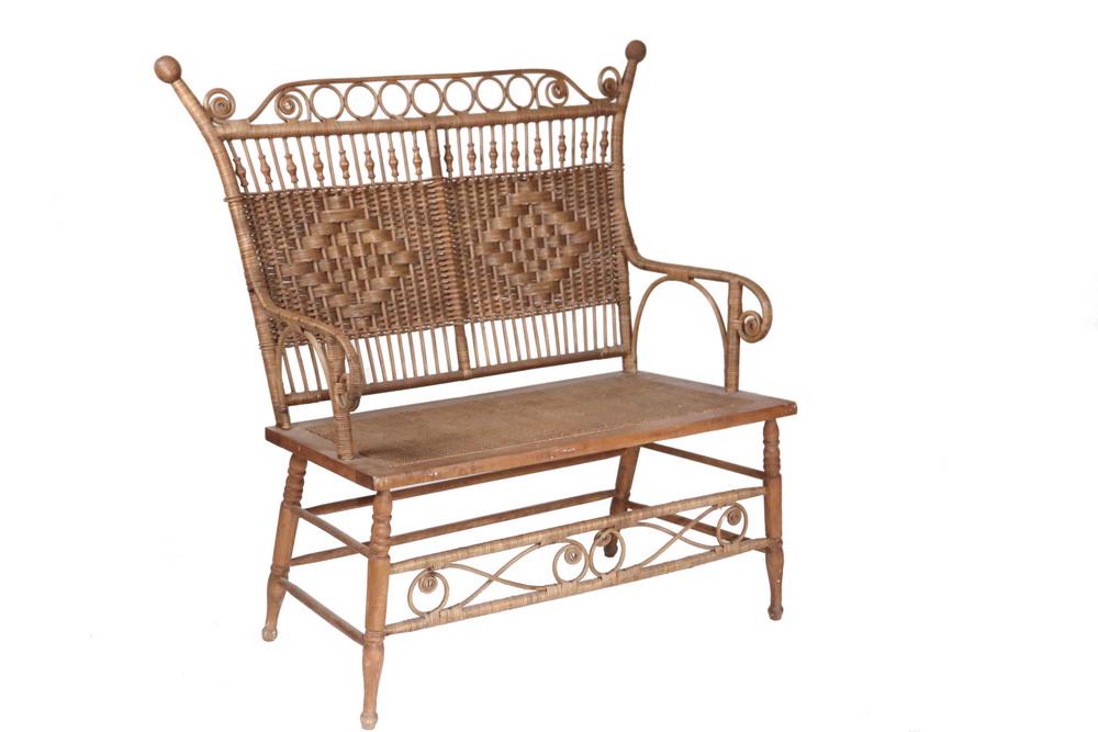 HEYWOOD-WAKEFIELD WICKER SETTEE: Victorian Bench, circa 1880, in natural finish with beads, curls and decorative weaving, 17" seat, 43" back, 36" x 22". Good condition.