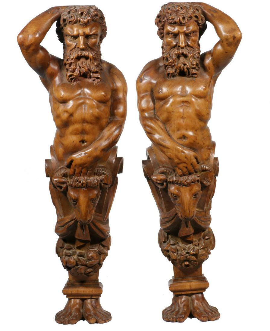 PR OF 19TH C. ARCHITECTURAL FRAGMENTS: Finely carved wood male figures, left and right, with goat heads and laurel wreaths on midsection. In a natural wood finish. 24" high, 8" wide x 5" deep.