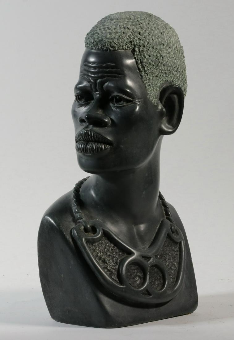 NICHOLAS TANDI (ZIMBABWE, 1948 - ): Shona Greenstone Bust Portrait of African Male, signed N. Tandi, 14" high, 8" x 6". Light scratches. Provenance: From the Estate of Rosemarie Wolfe, Cape Elizabeth, ME.