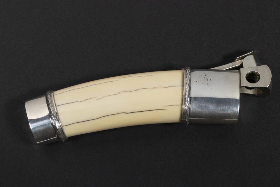 SILVER MOUNTED CIGAR CUTTER: Boar's tusk cutter with top and bottom silver mounts, marked 925, stainless cutter marked 'Donatus, Solingen, made in Western Germany', 6 1/2" long. Good Condition.
