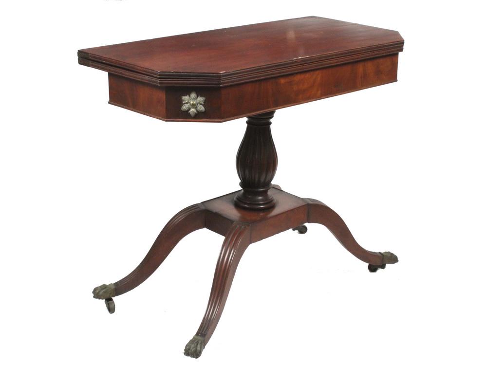 CARD TABLE: Duncan Phyfe Style Mahogany Card Table with twist and flip top, canted corners, brass starbursts on the corners of the skirt, reeded urn form column resting on platform with four reeded sabre legs, en