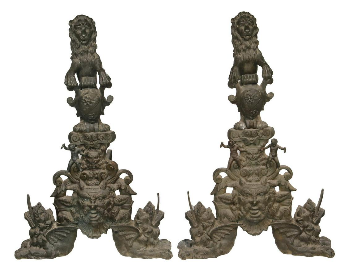 LION FIGURAL ANDIRONS: Large and Ornate Cast Bronze Figural Andirons, each depicting rampant lions atop multiple figures and grotesque masks, bases flanked by recumbent lions with extended tongues, with iron log rests, 34 3