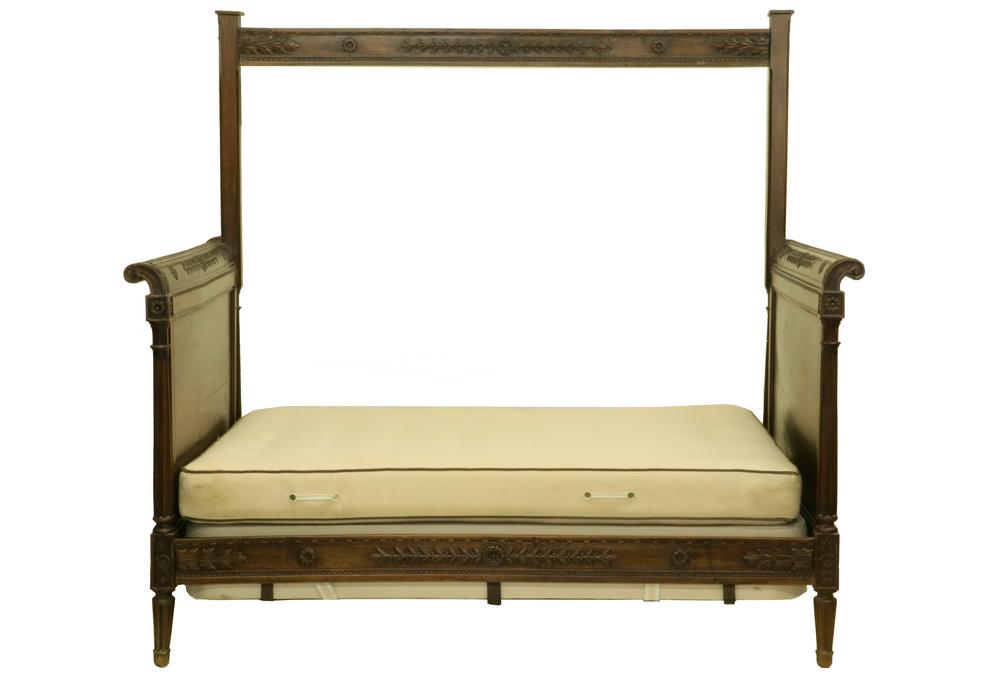 FRENCH DAYBED: Louis XV Style Walnut Daybed with back drape rail, circa 1910s, leaf, blossom and scroll carved, 75" tall at back, 45" tall at front, 49 1/2" x 80 1/2". Good condition. Box spring and mattress not inc