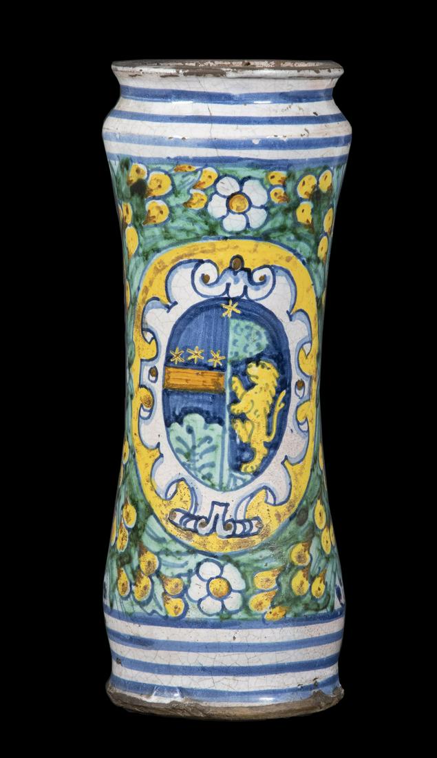 EARLY ITALIAN MAIOLICA ALBARELLO: 17th c. Glazed Earthenware Storage Jar, waisted cylindrical shape with polychrome heraldic decoration, with antique label affixed to back, 11 1/2" high, 4 1/4" diam. Hairline cracks, crazing, small ri