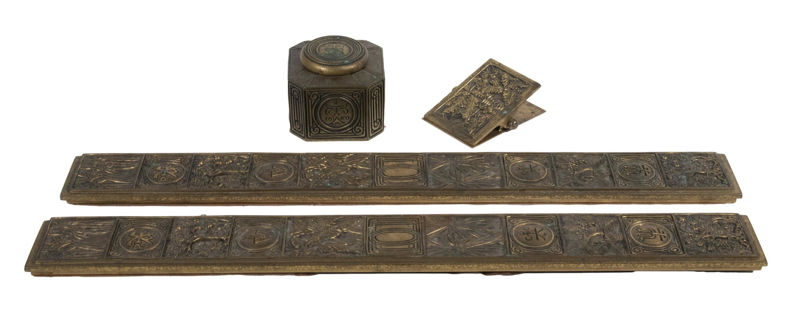 TIFFANY STUDIOS BRONZE "BOOKMARK" DESK ITEMS: Lot of (4) c. 1920 Gilded Bronze Accessories by Tiffany Studios, Bookmark pattern, incl: Pair of blotter ends, stamped "Tiffany Studios, 1002", 19 3/8" x 2 1/8"; Inkwell, with glass insert, base stamp