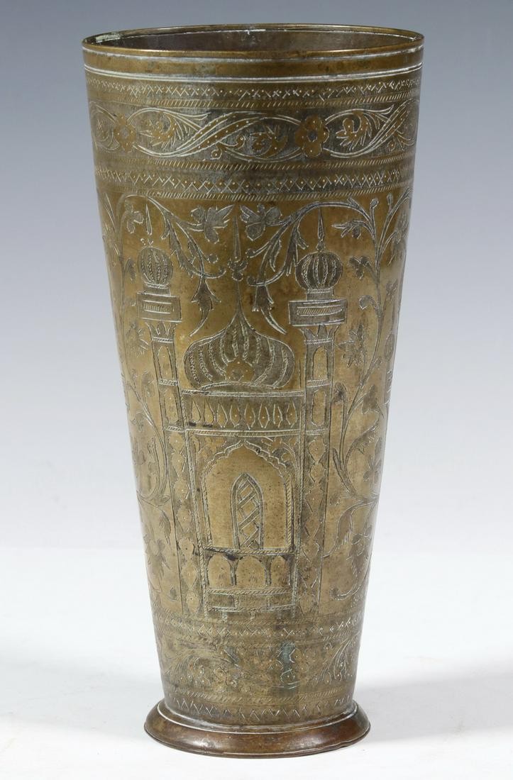 19TH C. PERSIAN TALL BRASS BEAKER: Footed and tapered cylinder, engraved with detailed image of a mosque, 8 3/4" x 4" diam. Good condition.