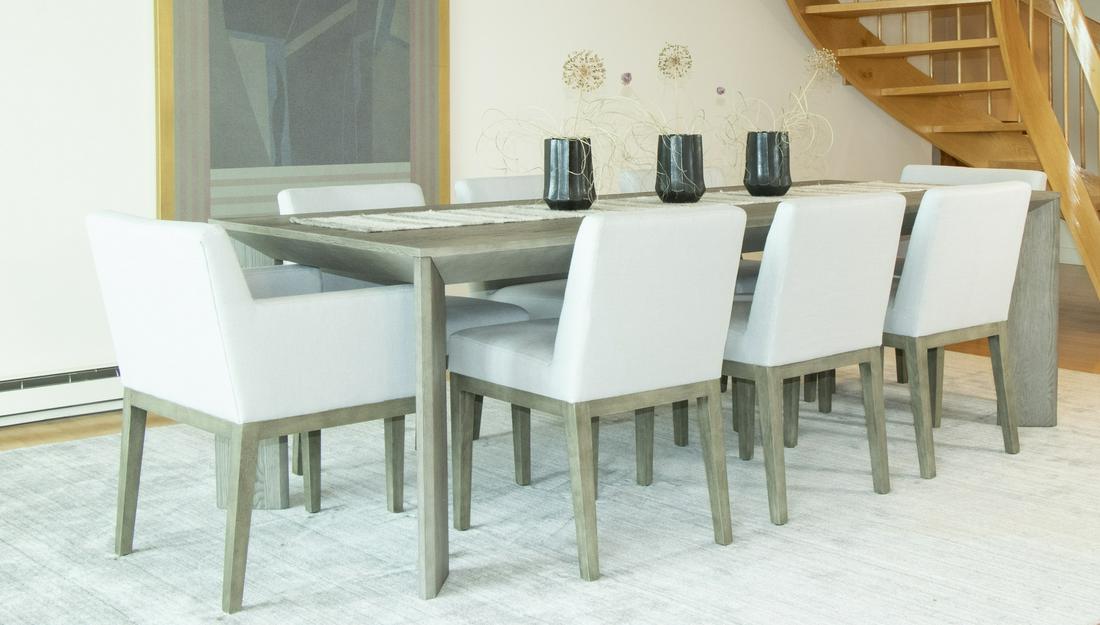 SET OF (8) UPHOLSTERED DINING CHAIRS: Set of eight dining chairs, two of which are armchairs, distributed by Restoration Hardware. Chairs feature a gray upholstered backrest and seat mounted on wooden legs stained a light gray. Dimensions