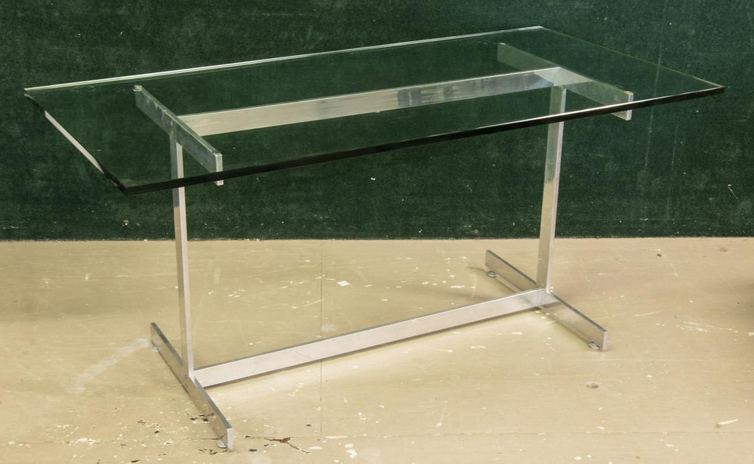 PLATE GLASS TOPPED CHROME METAL DESK: Modern style desk featuring a thick plate glass top supported by chrome metal frame, possibly by John Vesey. Glass Top Dimensions: 30" x 60" x 3/4". Frame Dimensions: 23" x 42" x 27".