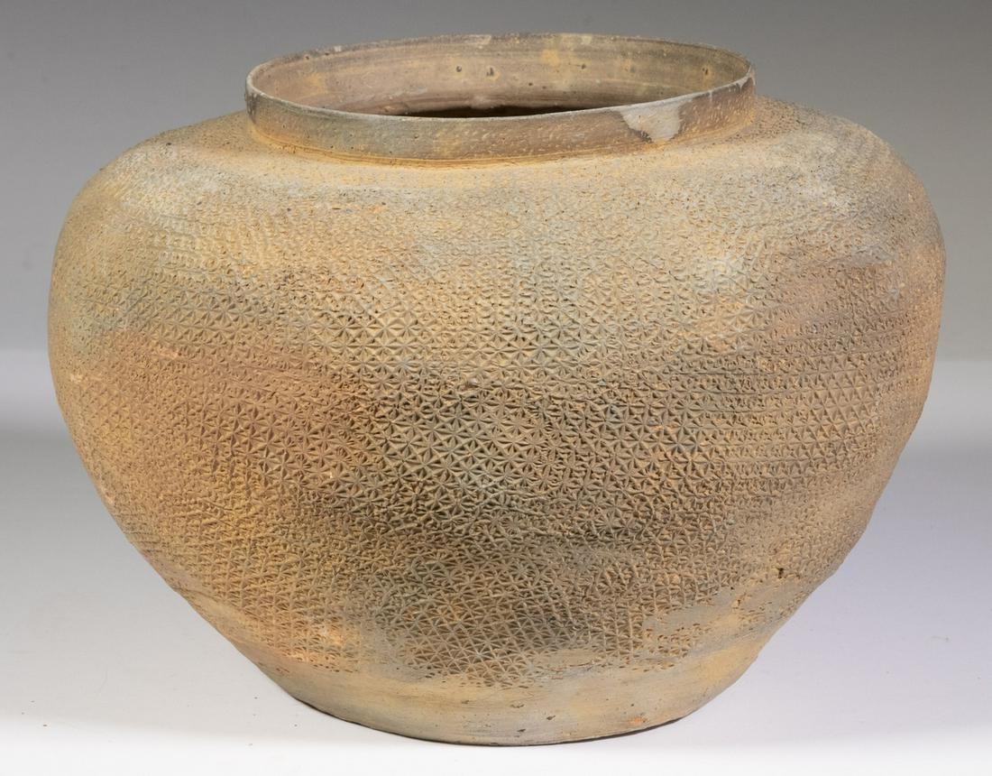 WARRING STATES, EASTERN ZHOU, (4TH C. BC) MEDIUM JAR: South China grey clay pottery bulbous jar with terracotta slip, unglazed, broad collared mouth, the body with overall fine impressed textile decoration, 6 1/4" x 9". Provenance: Purchased from Robert