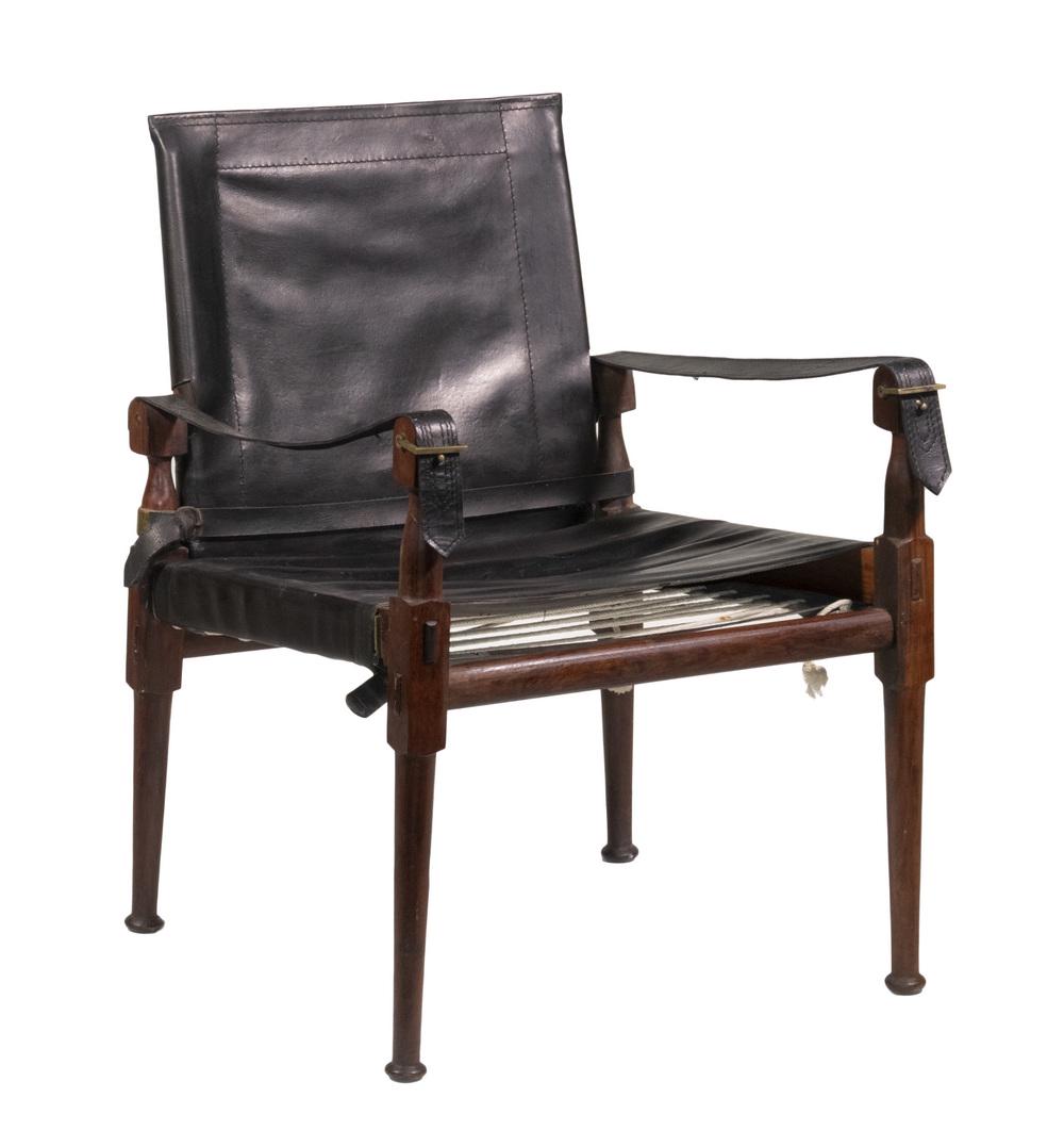 MID 20TH C. CAMPAIGN/SAFARI CHAIR MADE IN PAKISTAN: M. Hayat Brothers, Ltd. of Peshawar, Pakistan, in teak with black belting leather slings, cotton cording, made to disassemble with mortise and tenon joinery, brass hardware, 16" seat, 24" arms, 31" ba