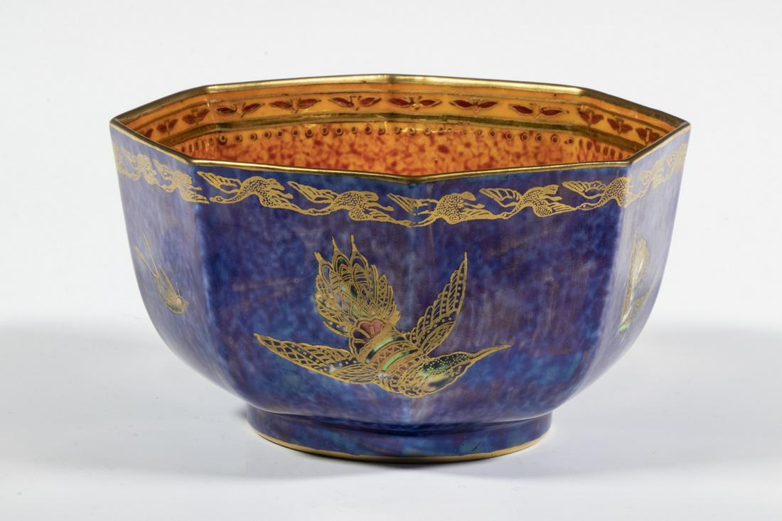WEDGWOOD FAIRYLAND LUSTRE HUMMINGBIRD BOWL: Circa 1920 English Octagonal Bowl, designed by Daisy Makeig-Jones, exterior with gilded images of birds in flight on a mottled cobalt lustre ground, interior with flying geese rim and centered with gi