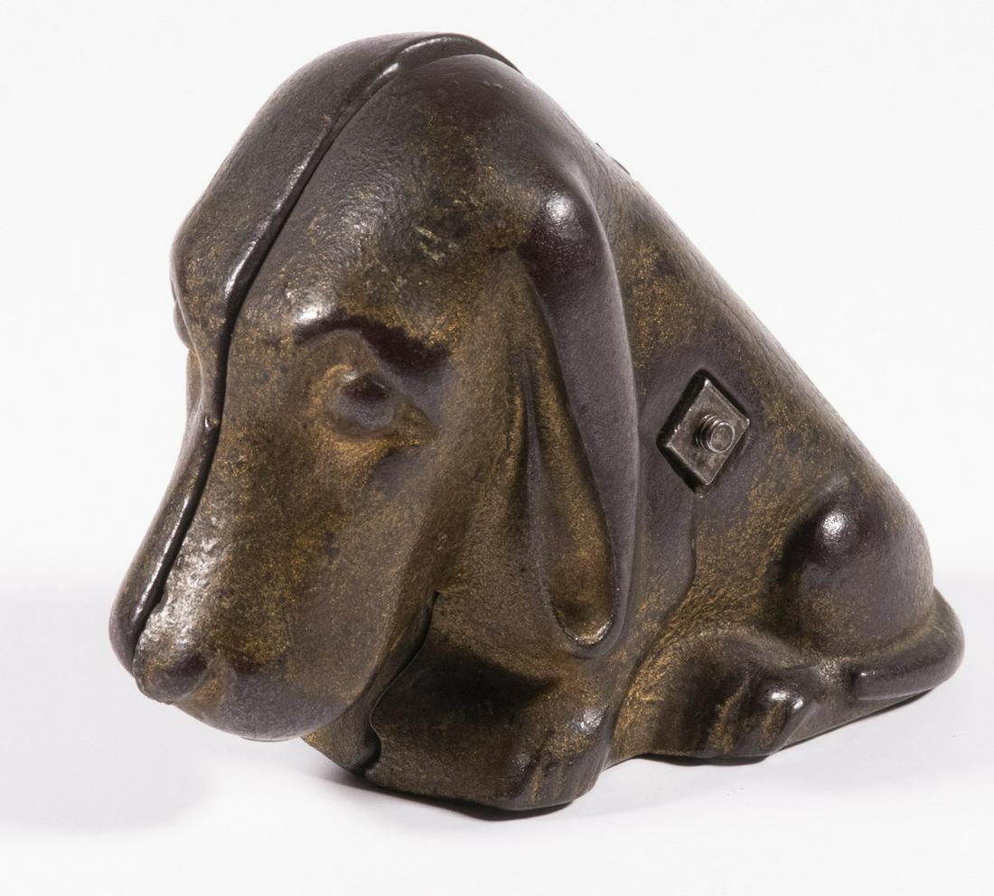 BASSET HOUND STILL BANK: Early 20th c. Cast Iron Bank by A.C. Williams (Ravenna, OH), in the form of a Basset Hound dog, with traces of original gold paint, 3 1/4" high, 2 1/4" x 4 1/4". Paint losses.
