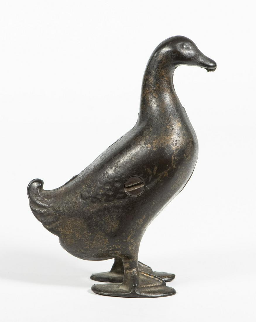 A.C. WILLIAMS DUCK FORM STILL BANK: Early 20th c. Cast Iron Figural Bank by A.C. Williams (Ravenna, OH), depicting a standing duck, with traces of gold paint, 5" high. Paint losses.