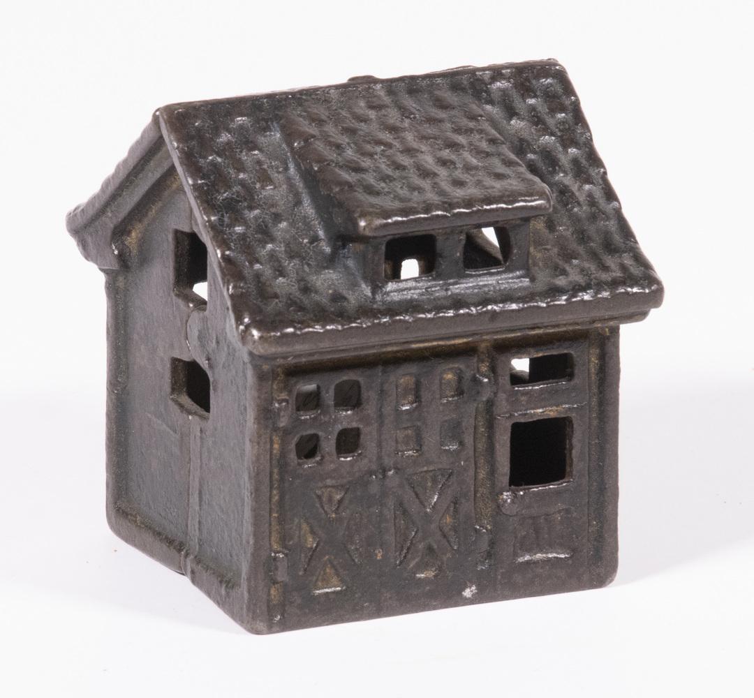 A.C. WILLIAMS ONE-CAR GARAGE BANK: Early 20th c. Cast Iron Still Bank by A.C. Williams (Ravenna, OH), in the form of a single bay garage, original surface, 2 1/2" high.