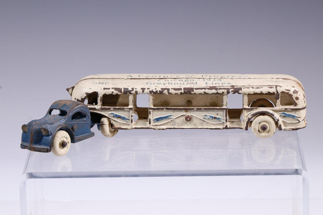 ARCADE GREYHOUND 'CENTURY OF PROGRESS' CAST IRON TOY: 1933 Cast Iron Greyhound Lines Toy Bus/Tram by Arcade Toy Co., sold at the Century of Progress Chicago World's Fair, with front tractor and attached bus, tractor interior stamped 'Arcade', 'USA' and '