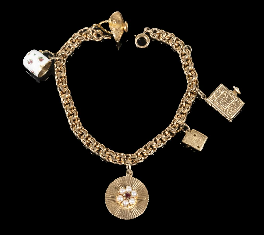 VINTAGE 14K GOLD LINK CHARM BRACELET: With 5 charms. 17.2 dwt. 7" long.