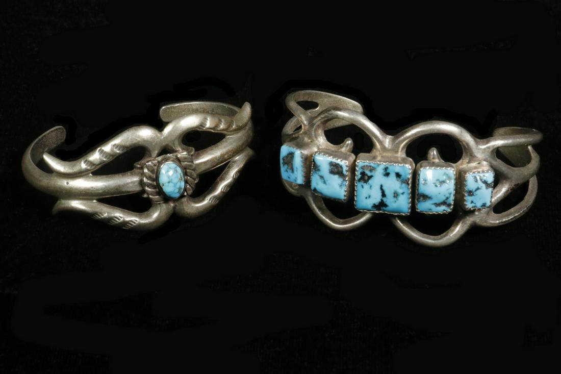 (2) NATIVE AMERICAN SILVER & TURQUOISE BRACELETS: Lot of (2) Openwork Cuff Bracelets, incl: Bracelet center set with small oval turquoise stone, unmarked, 1" wide, inner dimensions: 2 1/8" x 1 1/2", good condition; and Bracelet set with five square t