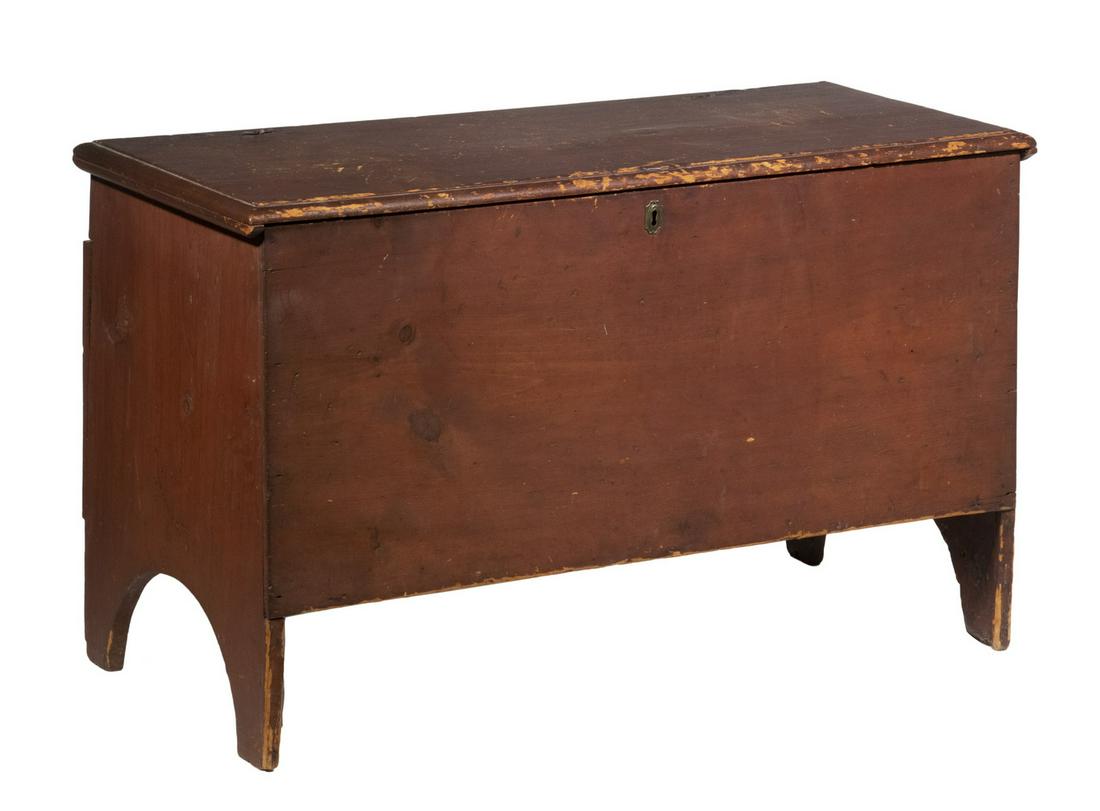 EARLY RED PAINTED BLANKET CHEST: 18th c. American Pine Lift Top Trunk, with red painted surface, board construction, molded edge top with original snipe hinges, brass lock escutcheon, boot jack ends, 20 1/2" high, 40 1/2" x 17". Pain