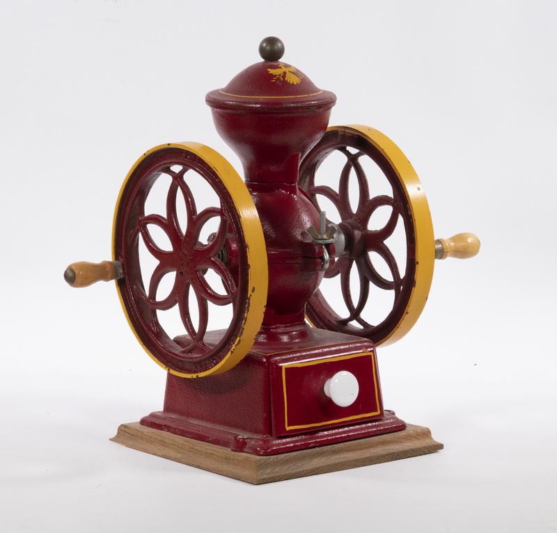VINTAGE JOHN WRIGHT COFFEE MILL: Mid-20th c. Red and Yellow Cast Iron Table Top Coffee Grinder, by John Wright Inc., Wrightsville, PA, with wooden drawer below the mill, wheel embossed with maker's name, set on a square wooden base,