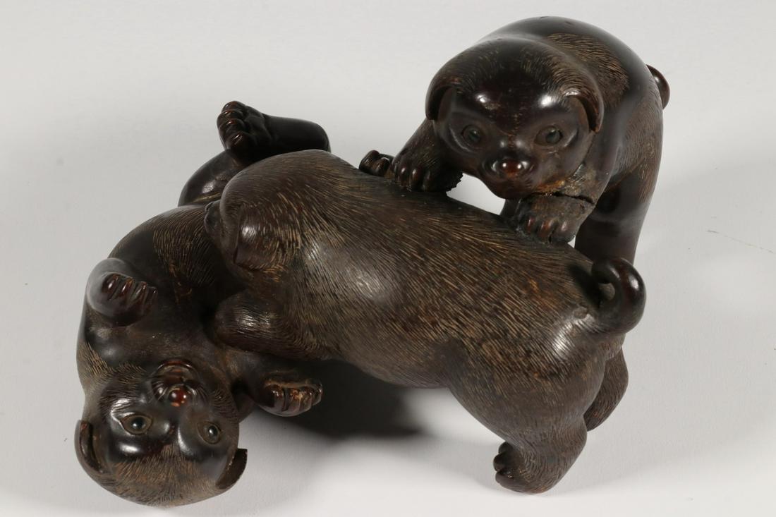 JAPANESE CARVED PUPPIES OKIMONO: Japanese Meiji Period Carved Wooden Okimono Figure of Three Frolicking Puppies, with nicely detailed faces and feet, from a single piece of wood, unsigned, 4 3/4" high, 8" x 6 1/4". Repaired front lef