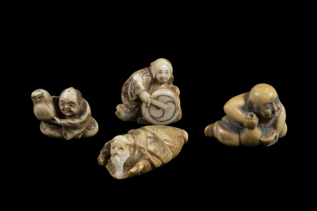 (4) JAPANESE IVORY NETSUKE: All signed, including: unusual Elder Man sleeping on stomach, 2" long; Female Drummer, 1 1/2"; Man with Baby, 1 5/8"; Seated Man drinking. Good condition.