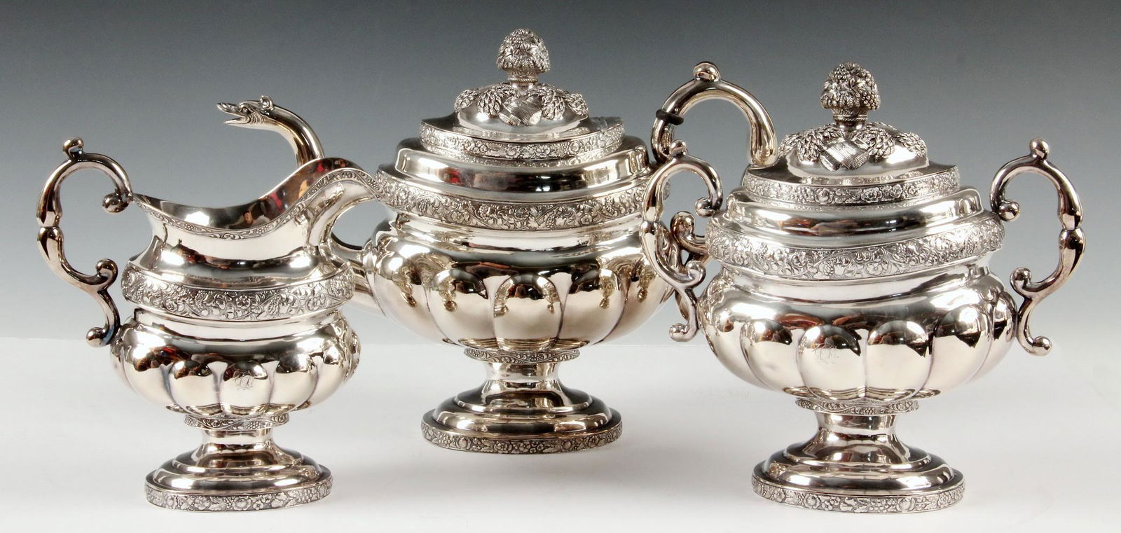 (3 PC) AMERICAN COIN SILVER TEA SET: American Federal Period Coin Silver Tea Service by John Crawford (NY, 1815-37; Philadelphia, 1844-45), footed form with molded grape and floral bands above lobed body, scroll handles, repousse sheaves