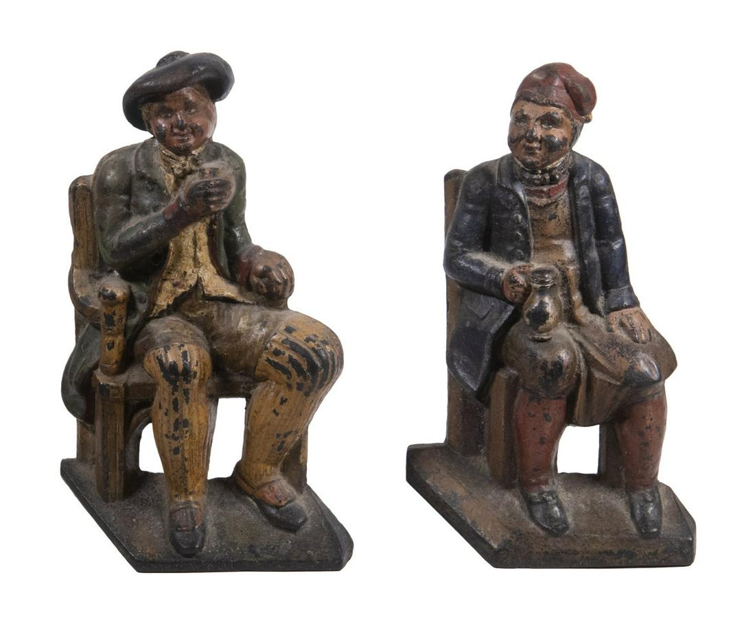 VICTORIAN FIGURAL DOORSTOPS: Lot of (2) 19th c. Painted Cast Iron Doorstops, depicting seated men holding mugs - probably at a tavern, original painted surface, unmarked, 9 ¾" and 10" high, 6" wide, 2" deep. Paint losses.