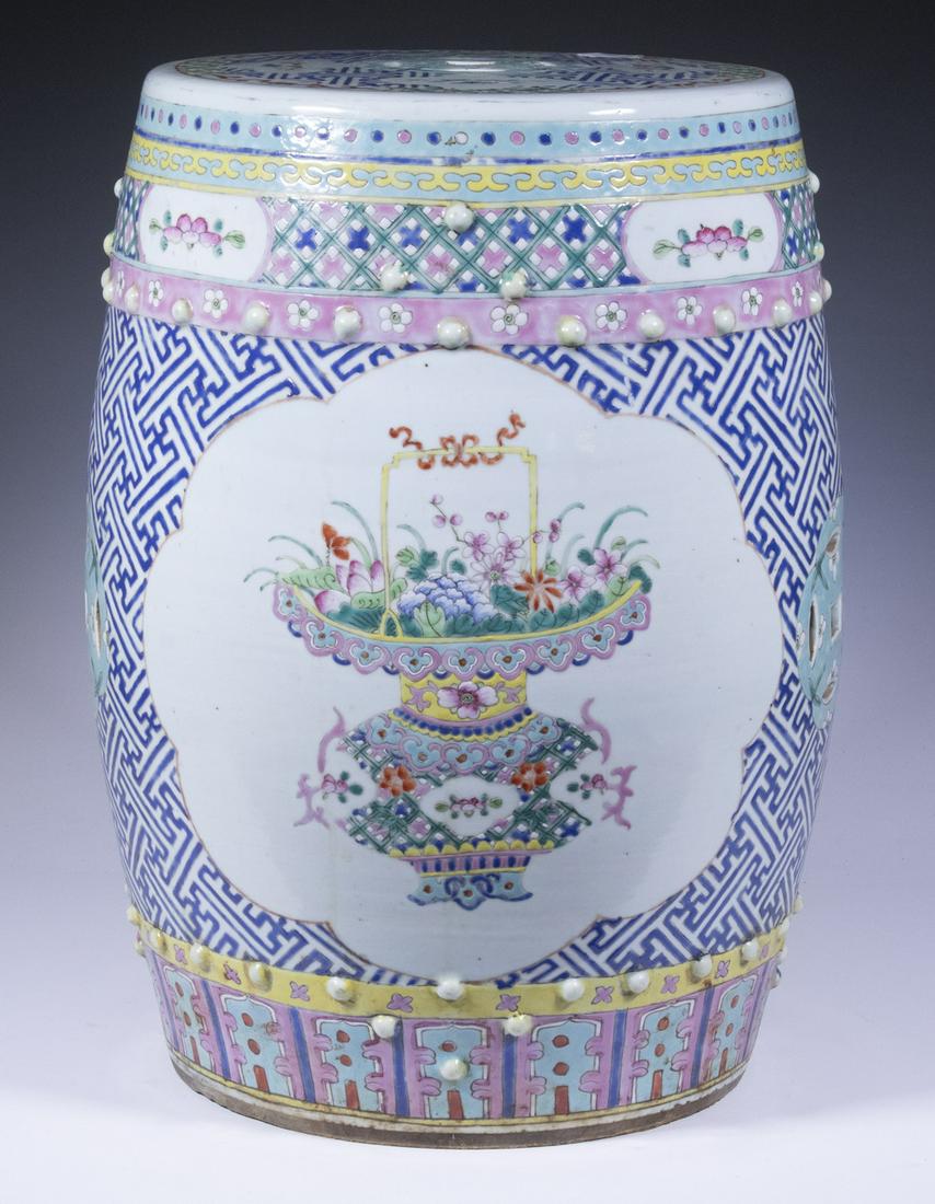CHINESE PORCELAIN GARDEN SEAT: Famille Rose Porcelain Barrel Form, with two rows of raised bosses, pierced coin symbols, and floral decorated front and back cartouches, 18 3/4" high, 13 1/2" diam. Purchased in 1965 from G. Malina I