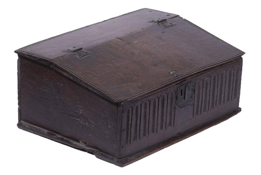 17TH C. OAK BIBLE BOX: Early English Slant Top Storage Box, having a butterfly hinged lid with molded edge, original iron escutcheon, carved nulling to the front panel, molded edge base, 10" high, 22 3/4" x 17". Wear commen