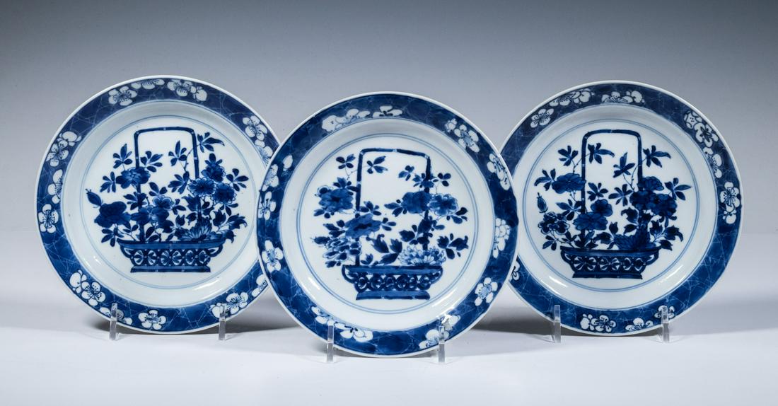 CHINESE BLUE & WHITE DISHES, KANGXI PERIOD: Set of (3) Late 17th- Early 18th c. Porcelain Plates, each decorated with a long handled basket filled with flowers, prunus border, with underglaze blue six-character Chenghua mark within a double cir