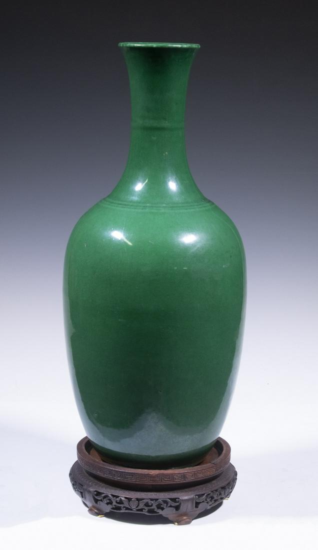 CHINESE MONOCHROME GREEN GLAZED VASE: 17th c. Chinese Emerald Green Porcelain Amphora Vase, early Qing Dynasty, with crackle glaze surface, flared rim, raised bands at neck and top of body, with carved wooden stand, with original purchase