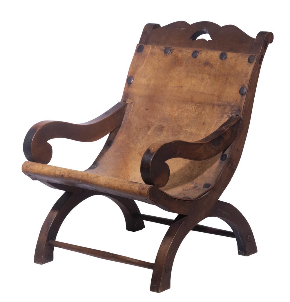 CAMPECHE ARMCHAIR, AFTER WILLIAM SPRATLING (1900-1967): Circa 1930s Mexican Hardwood & Leather "Butaquito" Armchair, early 20th c., after a design by William Spratling (1900-1967), having a shaped crest with pierced fish design, mortise and tenon construct
