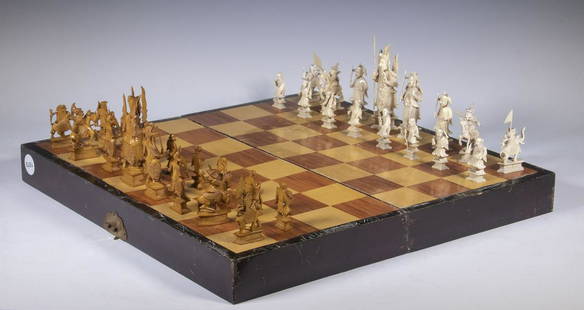 CHINESE CASED CHESS SET: A large Chinese carved ivory chess set with board, silk lined piece storage, second quarter 20th C. Tallest figures are 4". Box is 2" x 18" x 18" when open, 4" x 9" x 18" when closed.