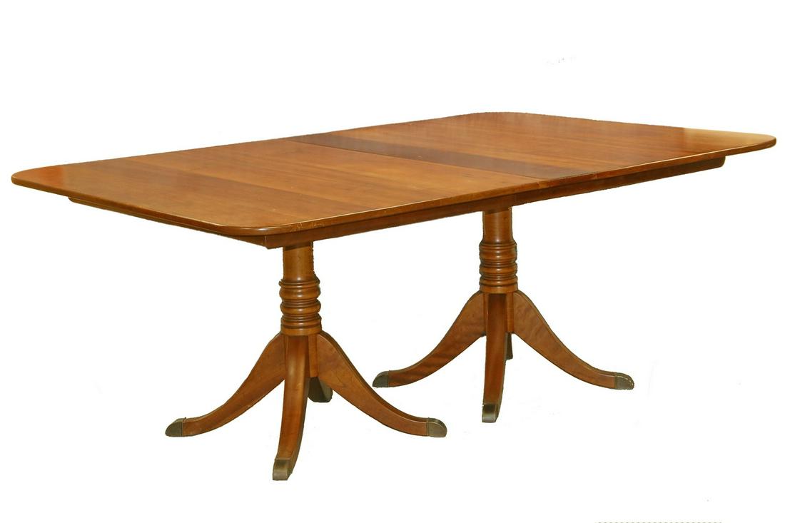 STICKLEY DINING TABLE WITH LEAVES: Two-Pedestal Duncan Phyfe Style Solid Cherry Dining Table with 4 Leaves by Stickley, having ring turned columns resting on four legs each, with brass caps. Label on underside. 29" x 49" x 72" with 12"
