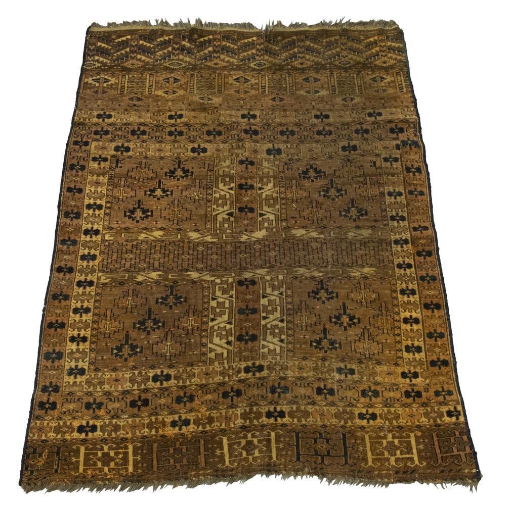 TEKKE ENSI (3'11" X 5'4"): West Turkestan, late 19th c. Quartered rust field filled with polygons in midnight blue and gold, with a rust and brown polygon and "pole tree" border. One large 20" tear at one end with even wear to 