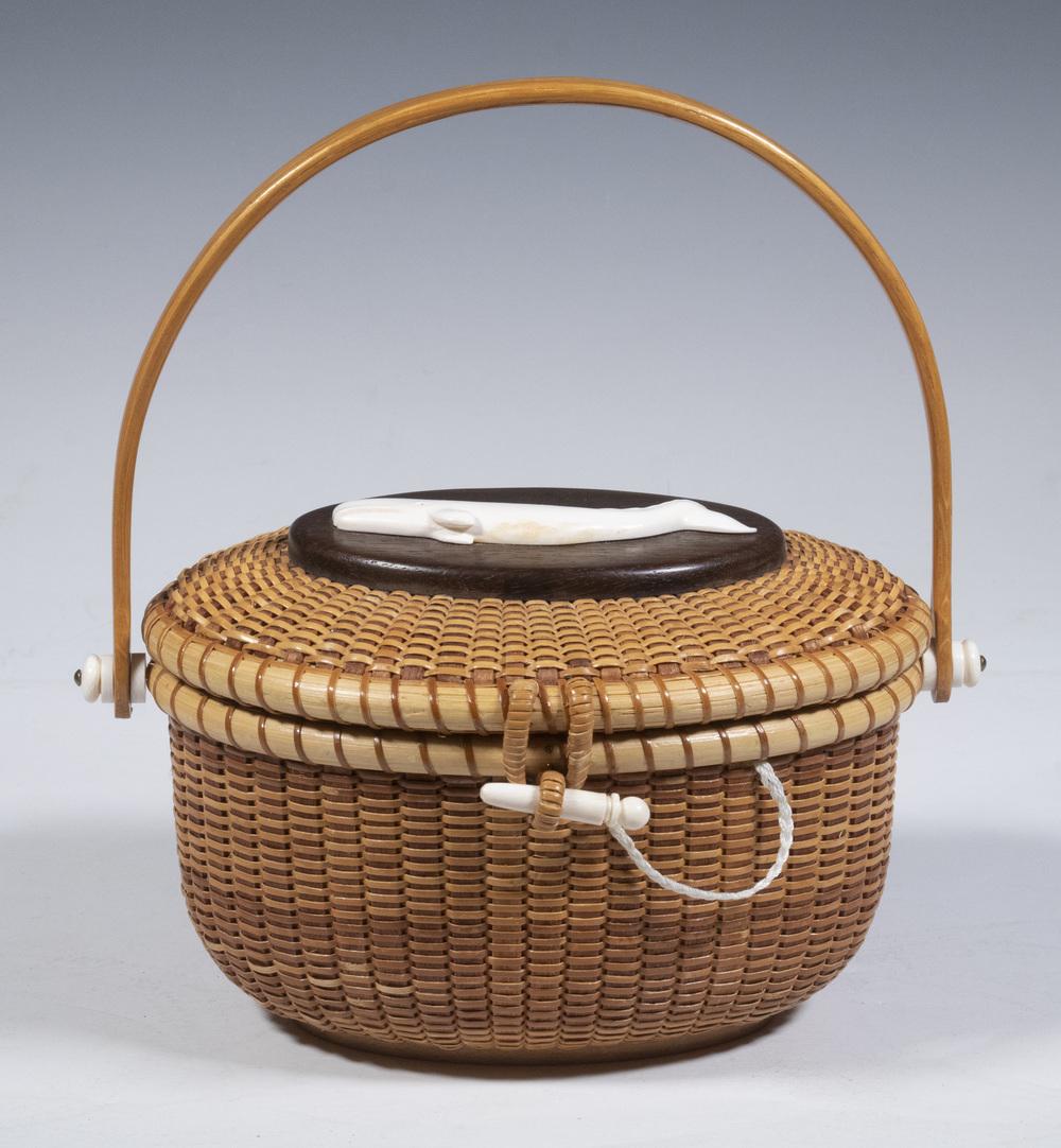 NANTUCKET BASKET PURSE BY PETER B. JAMES: Hand Crafted Oval Lightship Basket Purse, with whale figure mounted on malacca lid panel, lid interior plaque marked "Vann Thomson", bentwood swing handle, figured maple base panel with copper penny a