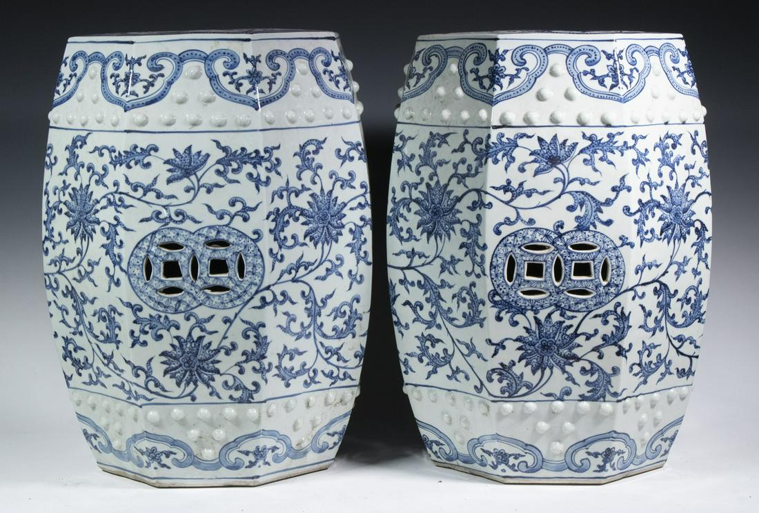PR CHINESE PORCELAIN GARDEN SEATS: Pair of Blue & White Porcelain Octagonal Barrel Form Seats, with trailing lotus and vine decoration pierced prosperity symbols, rows of raised bosses at top and base, 19" high, 13" diam. Good conditio